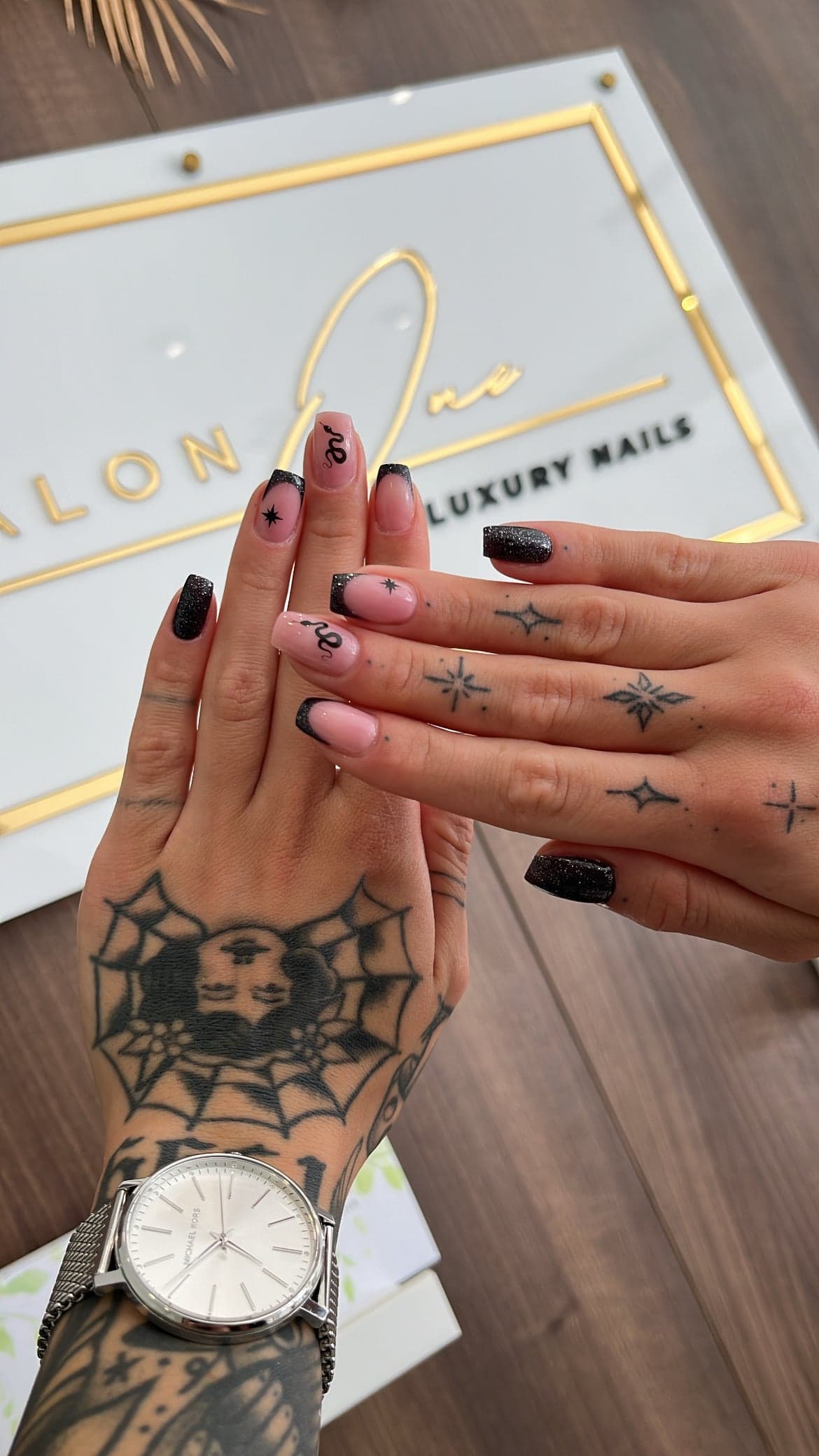Salon One Luxury Nails sign with manicured hand